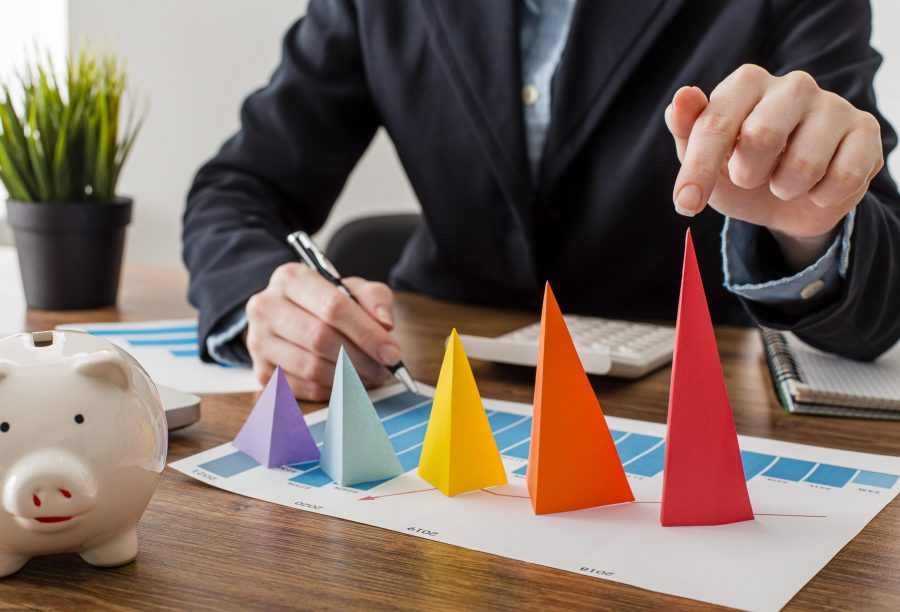 front-view-businessman-with-colorful-cones-representing-growth